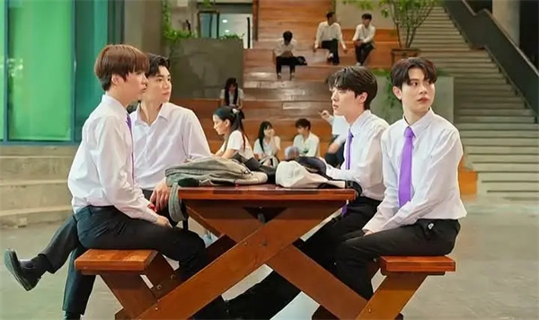 Characters sit and talk at a school outdoor area in "Four Ever You".
