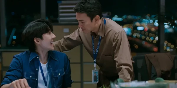 Two men interact in office at night in "Ossan's Love Thailand".