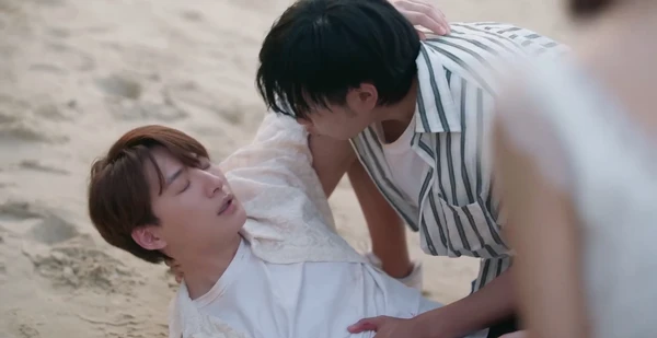 Man checks on injured person on beach in "The Ex-Morning".