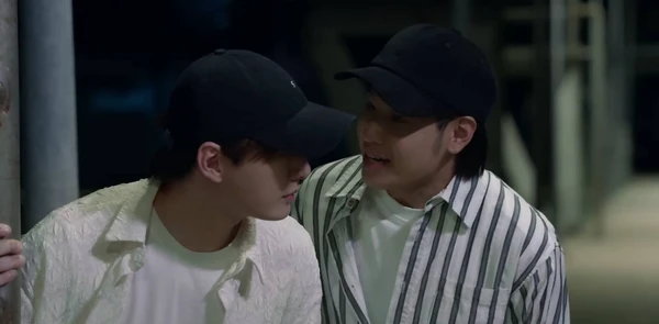 Two men in caps interact in "The Ex-Morning".